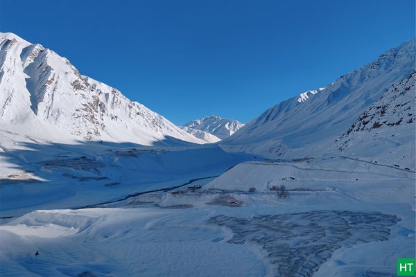 Mudh village in Pin Valley, Spiti, buried in fresh March snow under a clear blue sky — typical late‑winter (Jan–Mar) conditions.