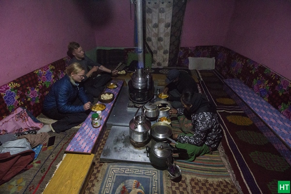 Dinner around a bukhari in a Spitian homestay—floor seating, simple food, and slow evenings you don’t get on road trips
